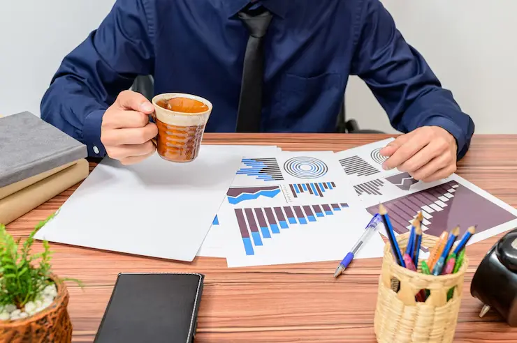 Businessman working at desk with coffee and Passive Income Crypto Strategy