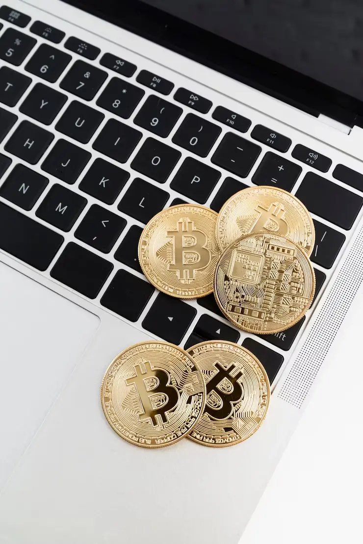 Cryptocurrency coins and gadgets illustrating Passive Income Crypto Strategy concept